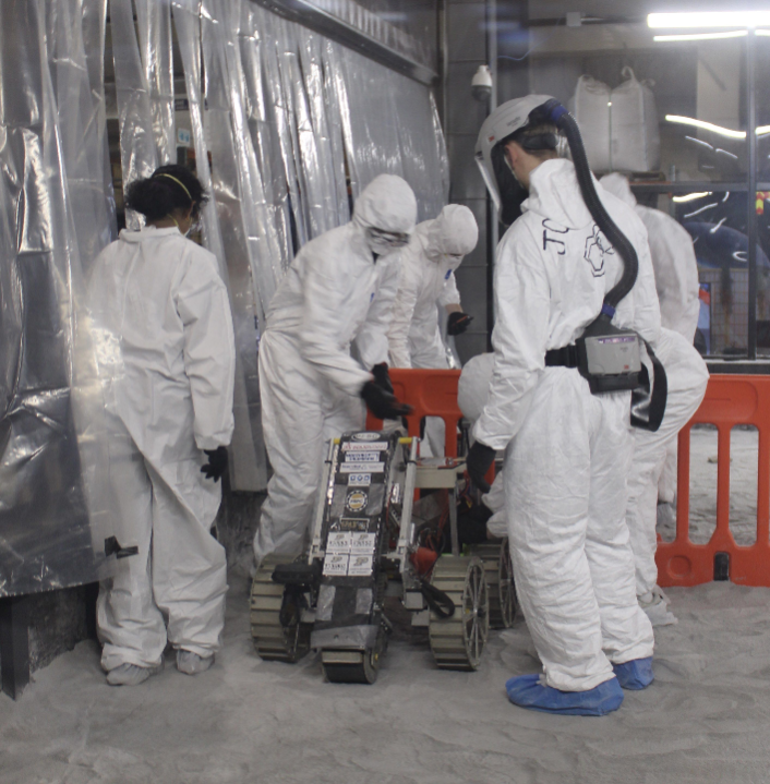 2024-25 Robot being emptied of regolith in the competition pit