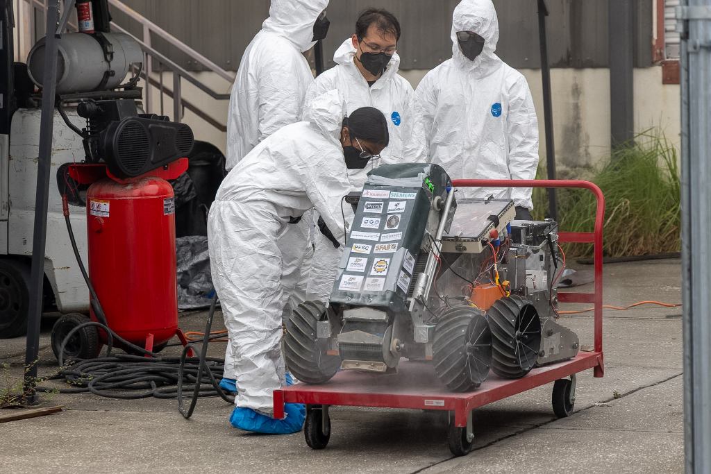 Team Members removing regolith from the 2026 robot