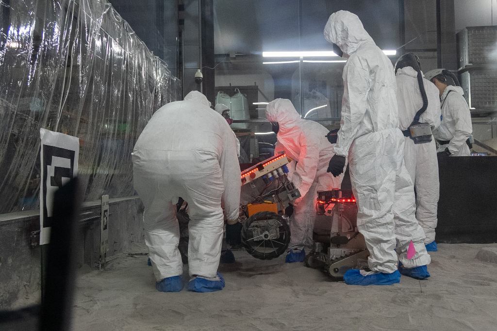 Team Members placing the robot into the pit